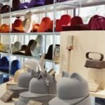 Artisan de Maison Michel travaillant une forme de chapeau en bois au 19M à Paris