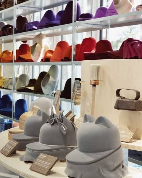Artisan de Maison Michel travaillant une forme de chapeau en bois au 19M à Paris